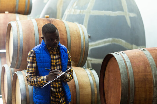 African American man counting tanks in a brewery