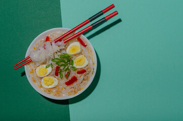 White plate with ramen and eggs in a green background in pop art style.