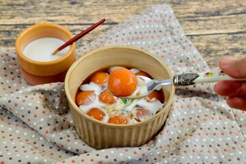 Kolak Biji Salak, Indonesian dessert, sweet potato balls in palm sugar syrup with coconut milk. Popular food for breaking the fast during Ramadan.