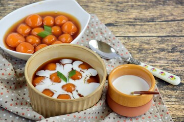 Kolak Biji Salak, Indonesian dessert, sweet potato balls in palm sugar syrup with coconut milk. Popular food for breaking the fast during Ramadan.