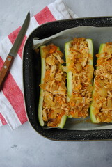 Stuffed Zucchini Boats with chicken, onions, and sour cream. Vertical photo, top view.