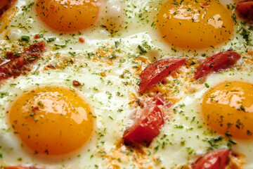 Fried eggs with tomatoes and spices.