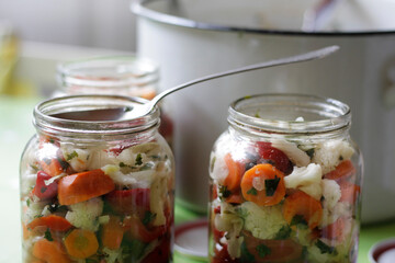Fototapeta na wymiar Pickle for winter in jars on the table 