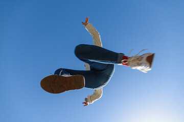 Jumping girl under the blue sky