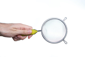 man hand holding strainer utensil. Kitchen concept.