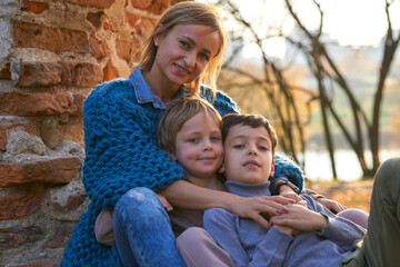 Obraz premium happy family mother and two boys on autumn walk