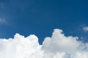 Naklejka na ściany i meble Clean white clouds below In the blue sky