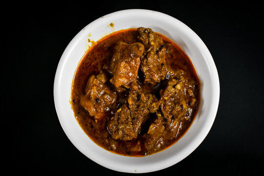 South Indian cuisine Kerala Style Beef curry / roast. Traditional style meat curry on Black background. Indian spicy curry. Selective focus photograph.