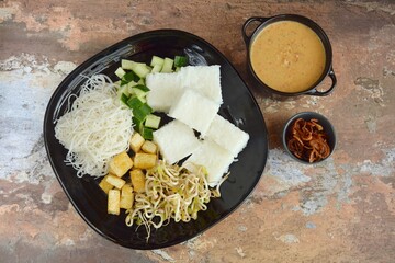 Ketoprak, vegetarian Indonesian food from Indonesia. consists of tofu, cucumber, rice cake, rice vermicelli and mung bean sprouts served with peanut sauce, soy sauce and fried shallot
