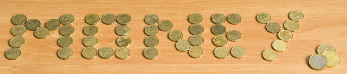 top view of the word money made with coins