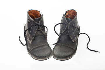 Old Black male shabby shoes isolated on white