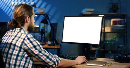 Picture of professional video editor editing video on his personal computer with two displays in...