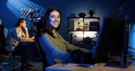 Picture of professional female video editor editing video on his personal computer with two...
