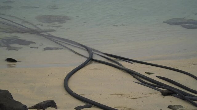 Desalination intake and outtake pipes going into warm water of an island in Fiji