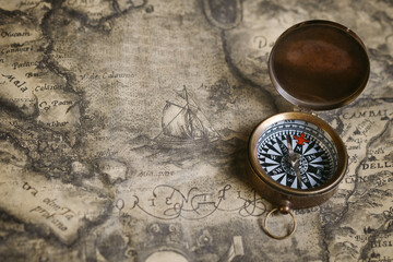 Fototapeta na wymiar old compass on old map
