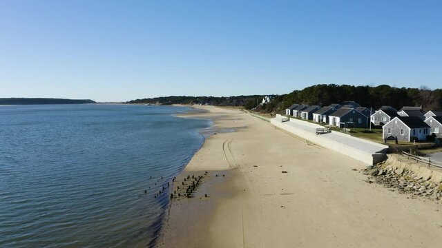 The camera flys up Mayo beach in Wellfleet harbor. You can see the town cottages and various coastal homes that are on the shoreline.