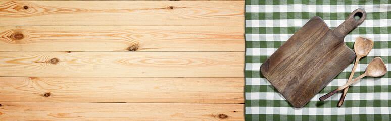 Empty cutting board and tablecloth on wooden deck table with napkin