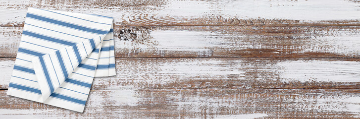 Empty wooden deck table with napkin tablecloth