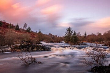 Long exposure of cold Scottish Highland stream at dusk, during winter.