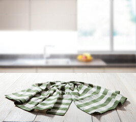 Table cloth on wooden deck table with napkin. Kitchen background.