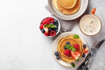 Fototapeta na wymiar Delicious pancakes with berries and coffee