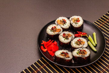 Korean roll Gimbap(kimbob). Steamed white rice (bap) and various other ingredients. Trendy black background