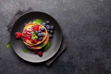 Fototapeta na wymiar Delicious homemade pancakes with summer berries