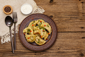 Dumplings stuffed stewed cabbage and sour cream. Traditional Ukrainian dish varenyky