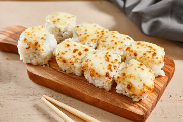 Baked shrimp rolls on wooden board top view