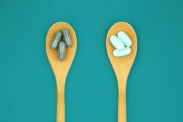 Wooden tablespoon with pills and capsules