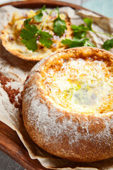 Cheese soup served in round bread loaf