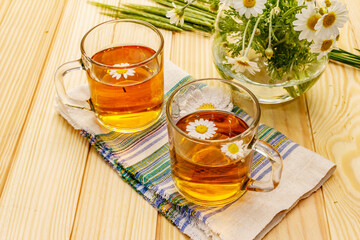 Chamomile tea. Fresh flowers, summer hot drink concept. Alternative medicine, lifestyle