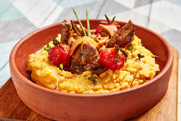 Hummus with beef served in brown bowl