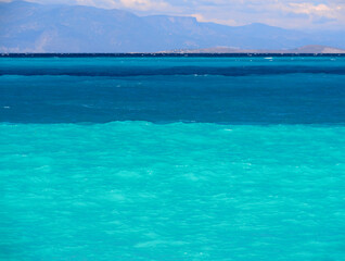 Fototapeta na wymiar Panoramic view of the sea water color gradient on the beautiful Psatha beach in the Corinthian Gulf of the Ionian sea in Greece on a Sunny summer day