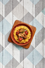 Hummus with beef served in brown bowl