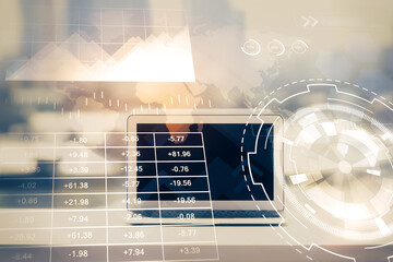 Forex graph hologram on table with computer background. Multi exposure. Concept of financial markets.