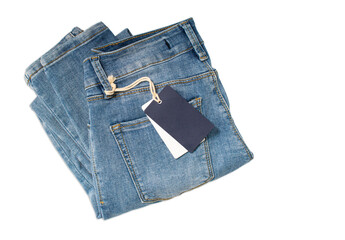 Blue woman folded jeans with a blue label tag isolated on white background.