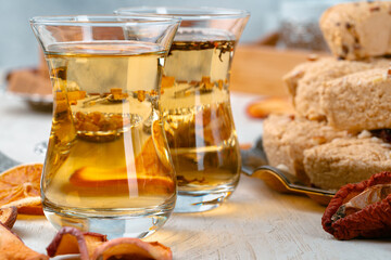Turkish halva with tea in a glass cup close up