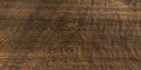 view from above on texture of gravel road with car tire tracks
