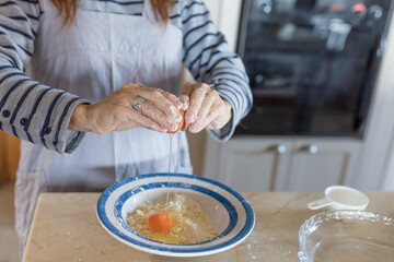 Woman cracking egg