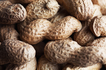 Healthy snack textured peanuts nuts. Healthy eating concept. Inshell peanuts closeup.