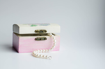 dangling pearls from a decorative jewelry box