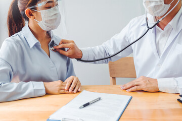 Doctor wear face mask and eyeglasses Measuring arterial blood pressure woman patient helping,...