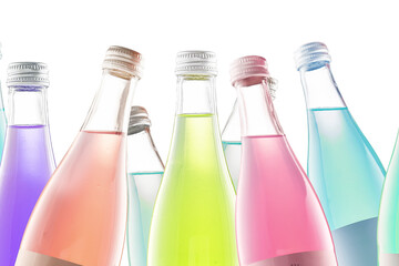 several colored colorful bottles with carbonated drinks and lemonade on a white background isolate
