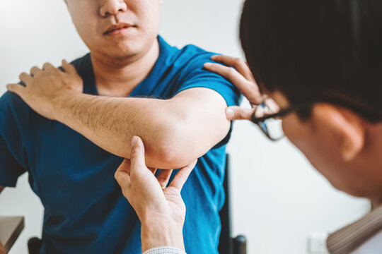 Physical Doctor consulting with patient About elbow muscule pain problems Physical therapy diagnosing concept
