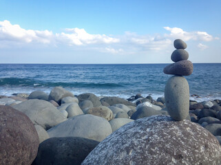 Stones stacked on rocky beach