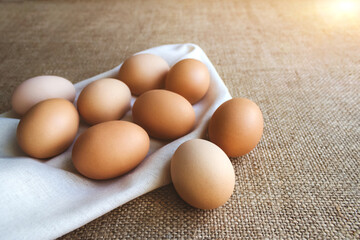Close up of fresh organic chicken eggs from local farmer market on tablecloth, selective focus. World egg day and healthy, organic food concept. Copyspace for your text or presentation