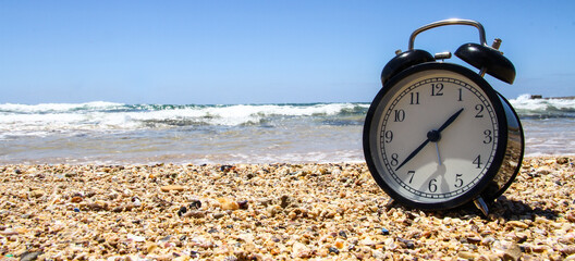 old alarm clock on the beach