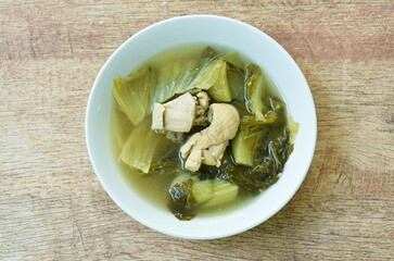 boiled pickled cabbage with chicken meat in clear soup on bowl