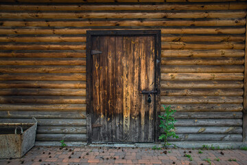 wooden door closed with an iron lock. Wooden wall
